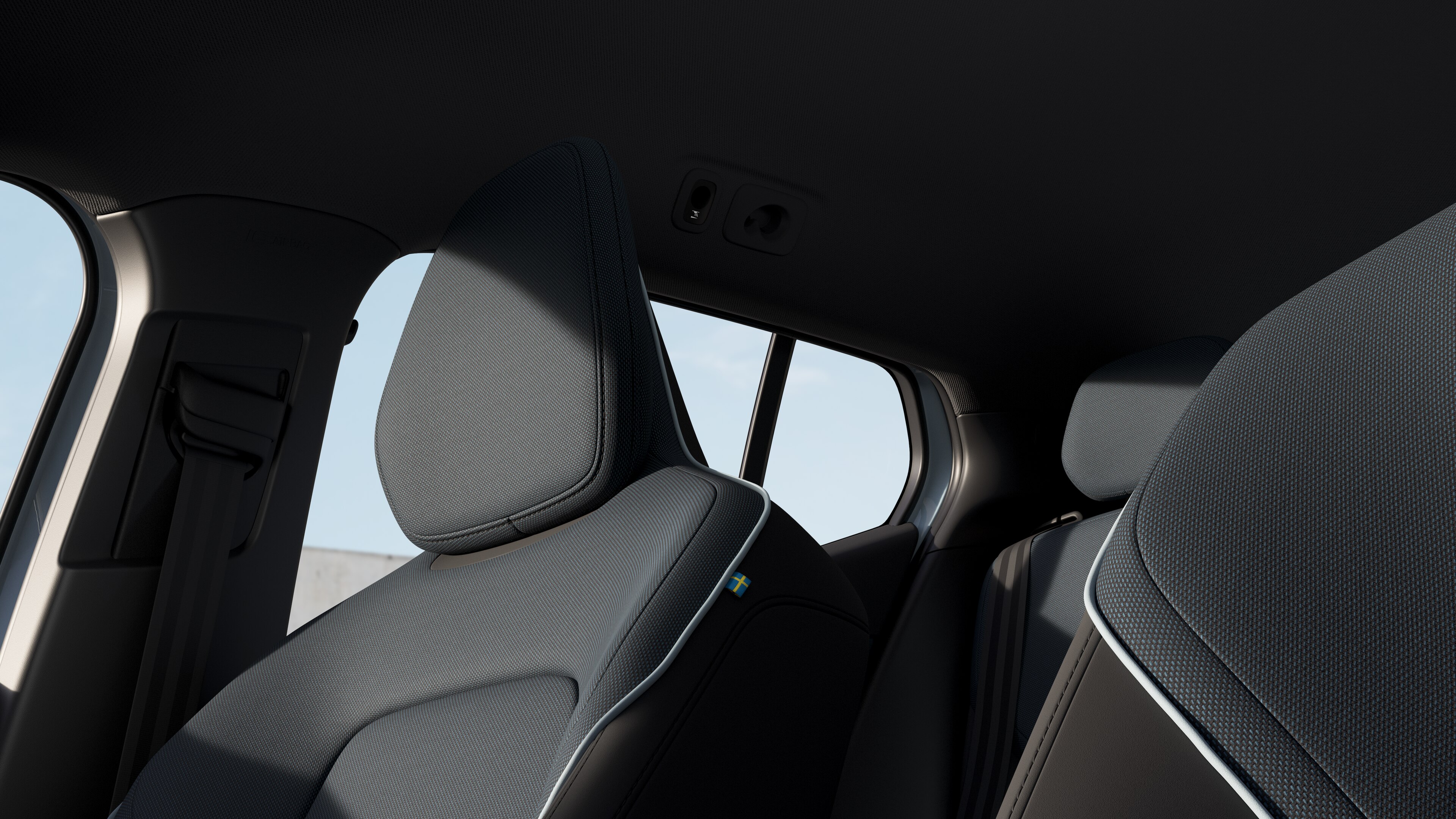 沃尔沃汽车内饰在朴素的工作室背景下展示了前后排乘客座椅、方向盘、仪表板和中控台。